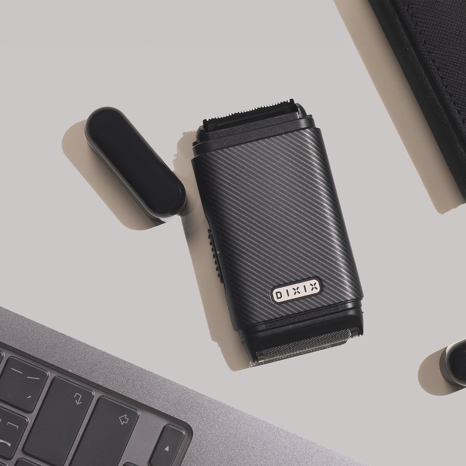 Black Dixie cup on a light gray surface with a laptop in the background