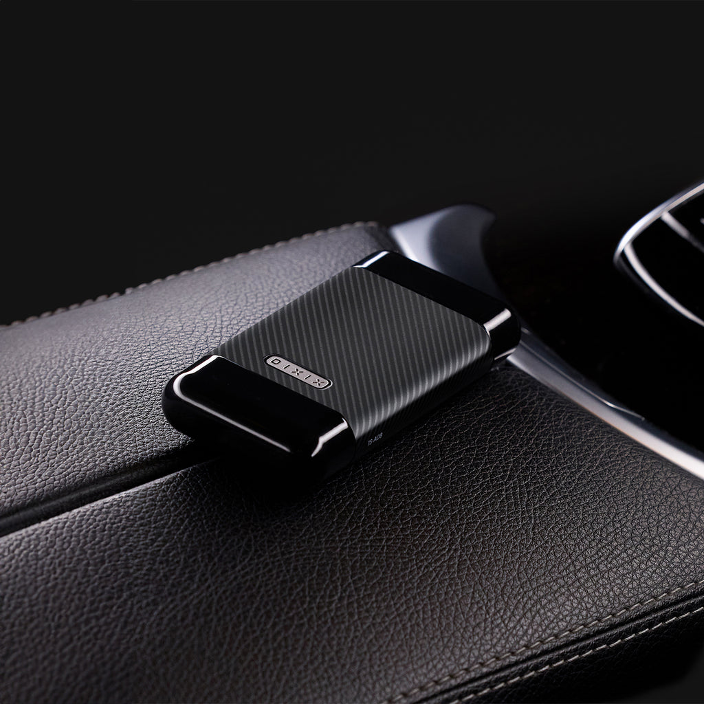 Black car phone holder attached to a car's air vent.